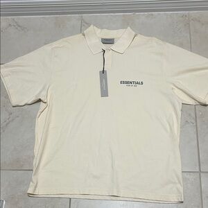 NWT ESSENTIALS Men’s Cream Polo with Chest Logo